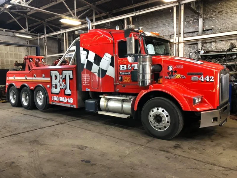 B&T heavy wrecker towing semi tractor on highway